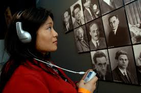 Young lady using a listening device in a museum.